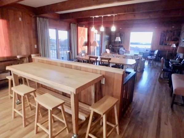 a view of a dining room with furniture and window