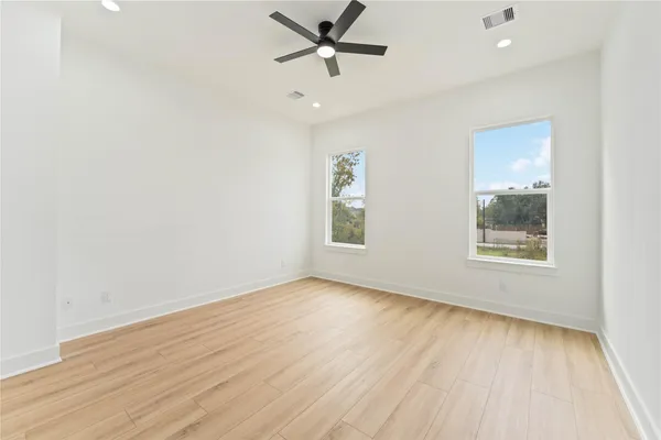 wooden floor in an empty room with a window