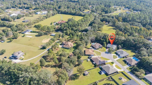 an aerial view of house with yard swimming pool and outdoor seating