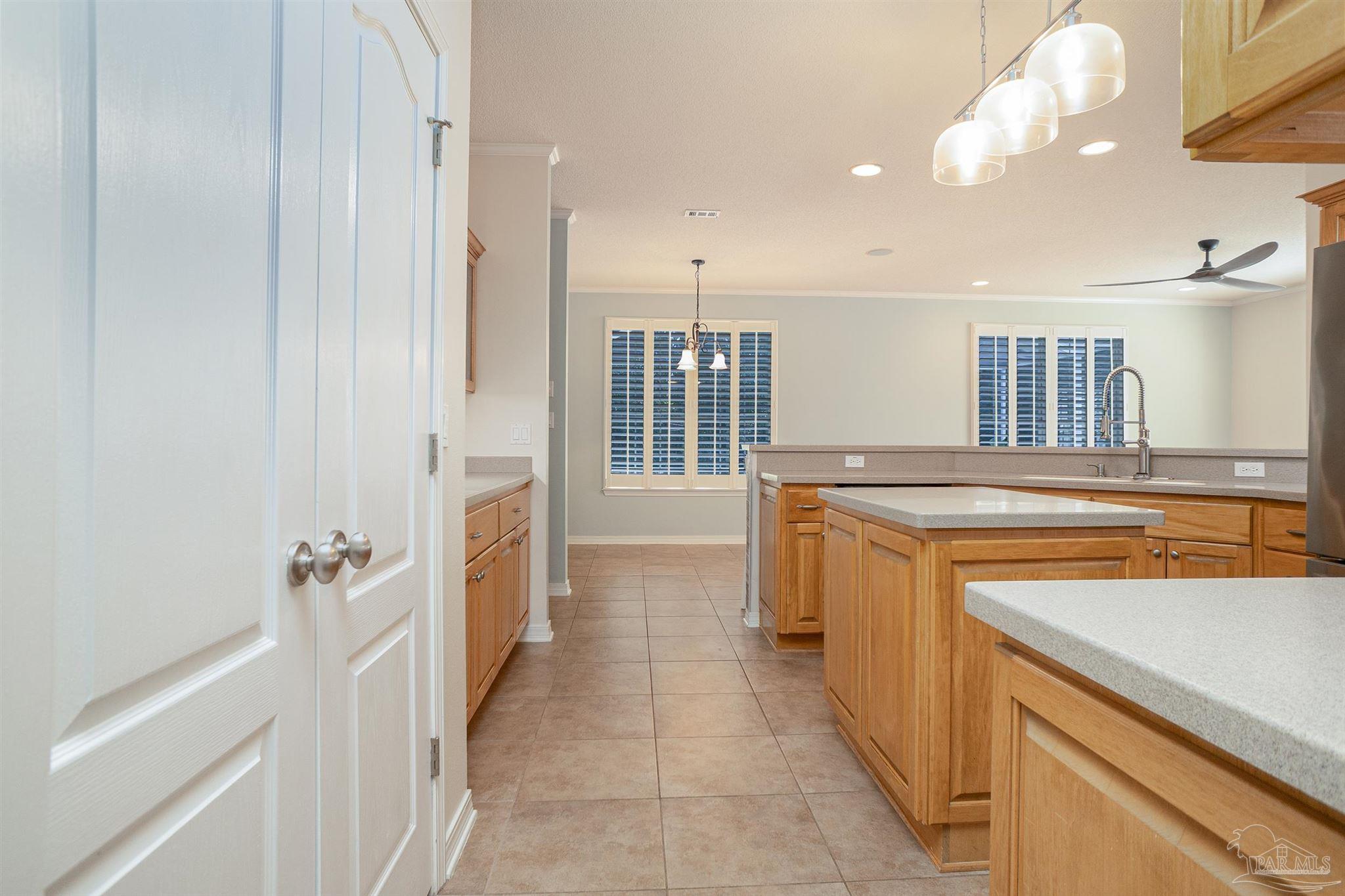 2351 Queens Ferry Lane Cantonment, FL 32533 - Photo 14 of 67 a view of a kitchen with a sink and dishwasher with wooden floor