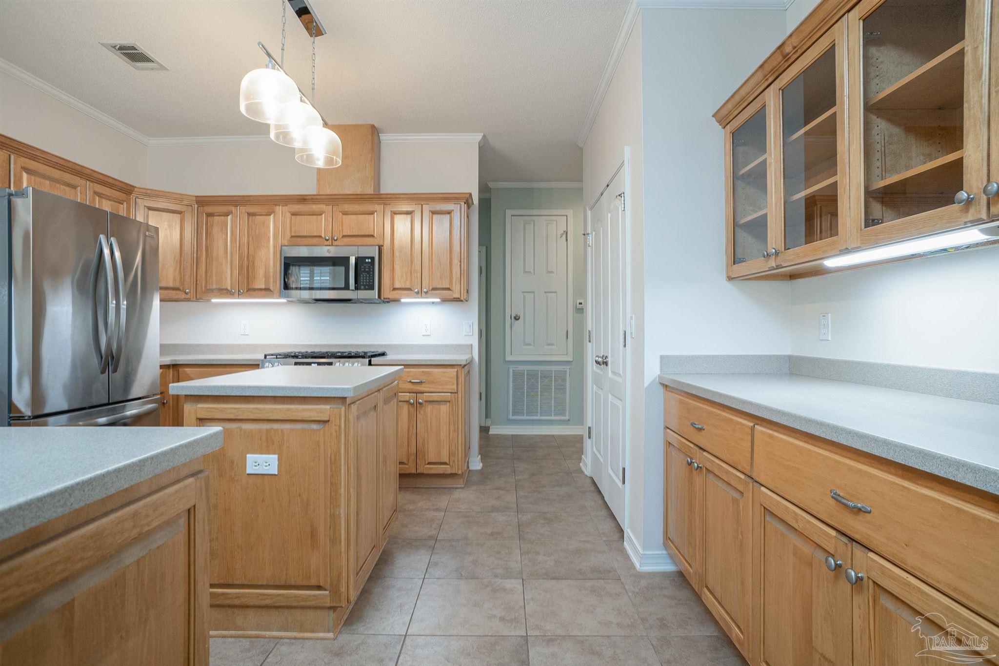 2351 Queens Ferry Lane Cantonment, FL 32533 - Photo 18 of 67 a kitchen with kitchen island granite countertop a sink counter top space stainless steel appliances and cabinets