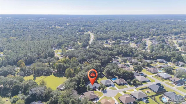 an aerial view of residential house with outdoor space and parking