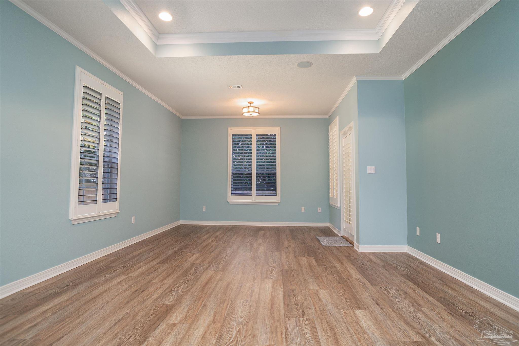 2351 Queens Ferry Lane Cantonment, FL 32533 - Photo 31 of 67 an empty room with wooden floor and windows