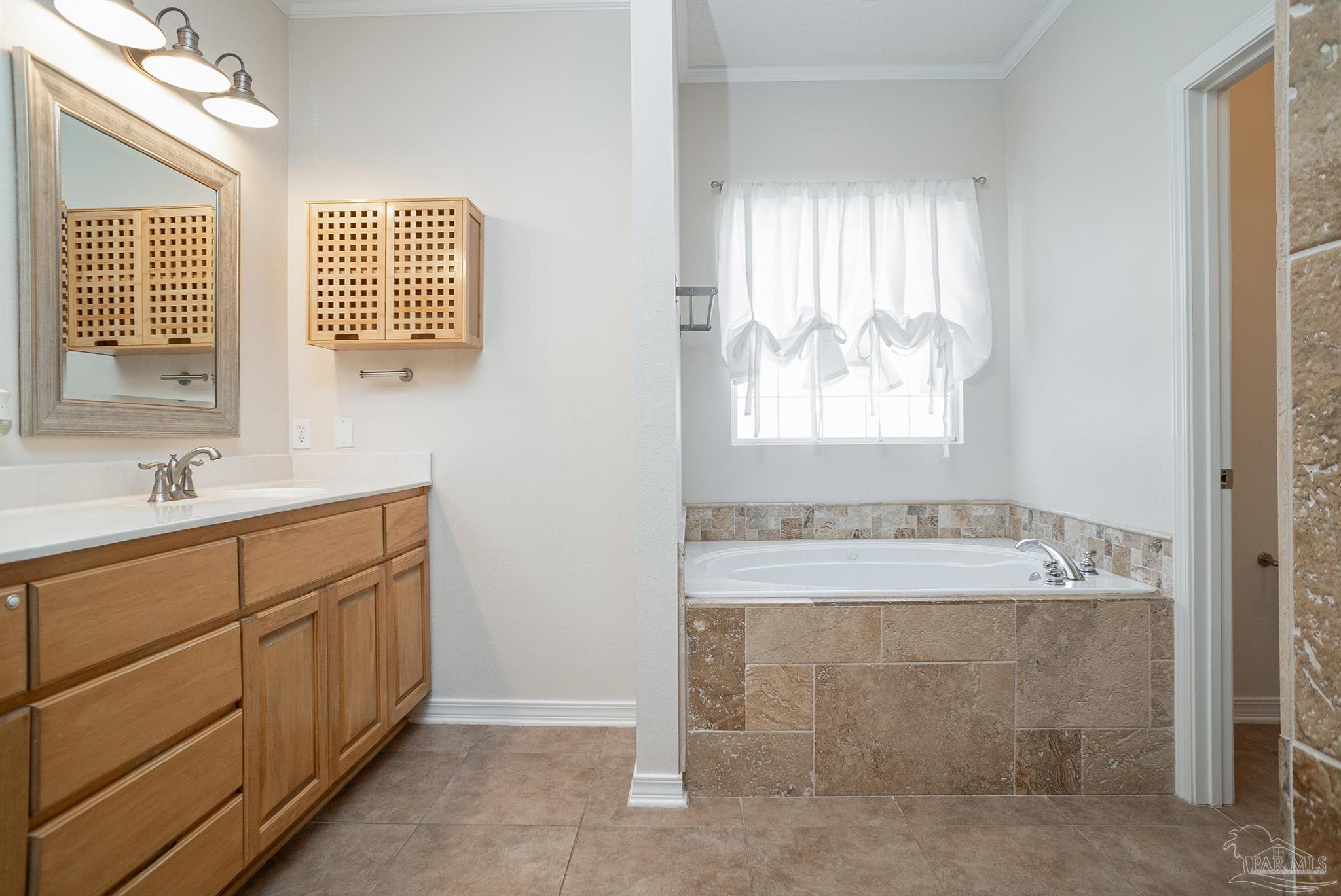 2351 Queens Ferry Lane Cantonment, FL 32533 - Photo 36 of 67 a bathroom with a tub sink and mirror