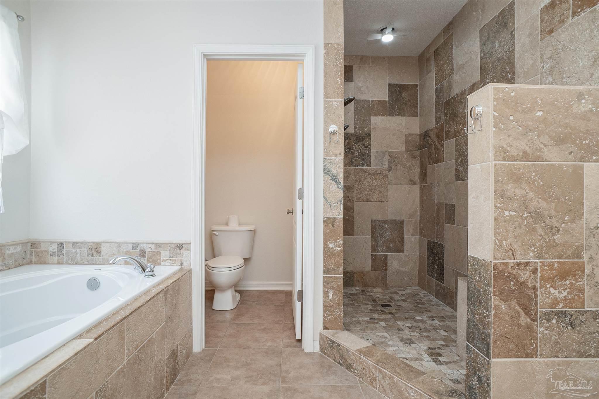 2351 Queens Ferry Lane Cantonment, FL 32533 - Photo 38 of 67 a bathroom with a bathtub and a toilet