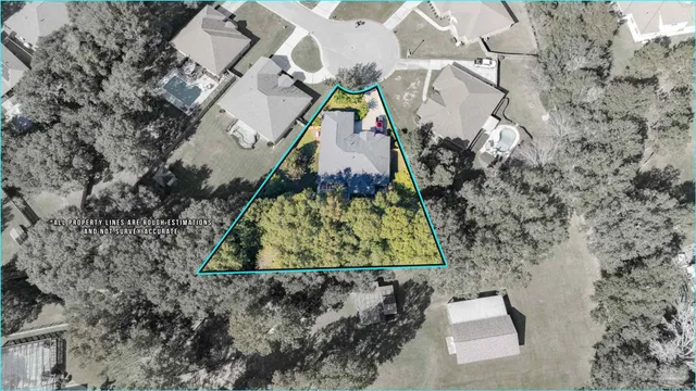 an aerial view of a house with a yard and swimming pool