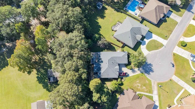 an aerial view of a house with swimming pool and outdoor space