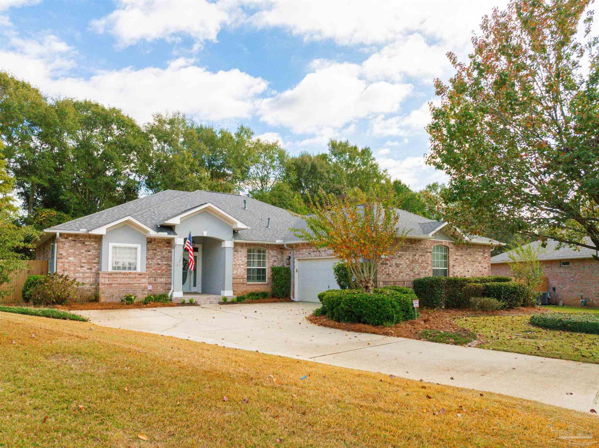 2351 Queens Ferry Lane Cantonment, FL 32533 - Photo 6 of 67 a front view of a house with a garden and pathway