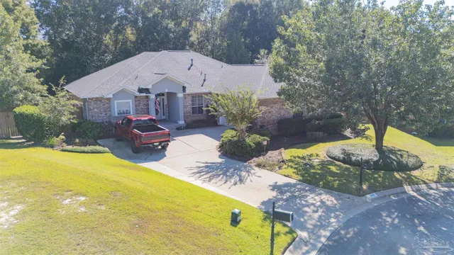 a front view of a house with a yard and a fountain