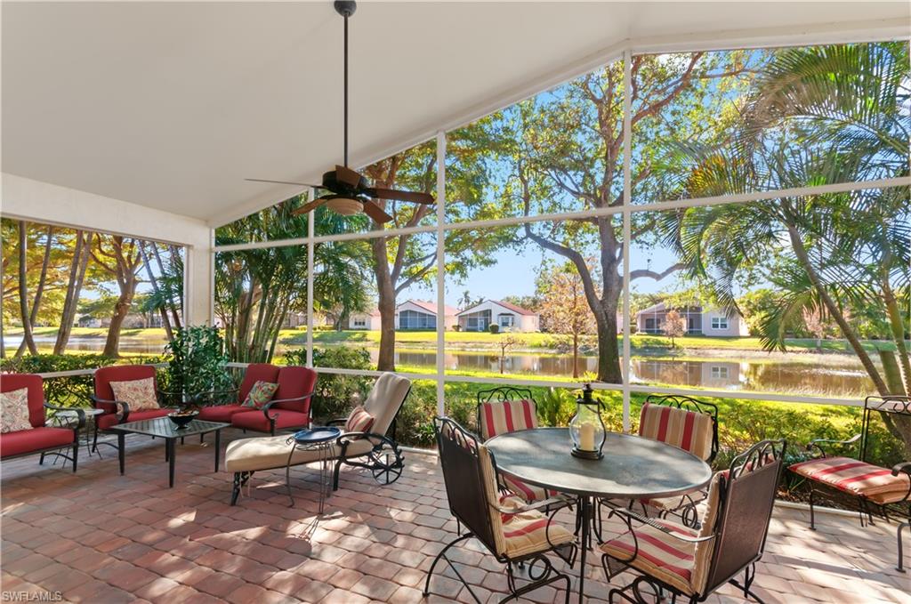 9387 Springview Loop Estero, FL 33928 - Photo 1 of 39 a living room with furniture and a floor to ceiling window
