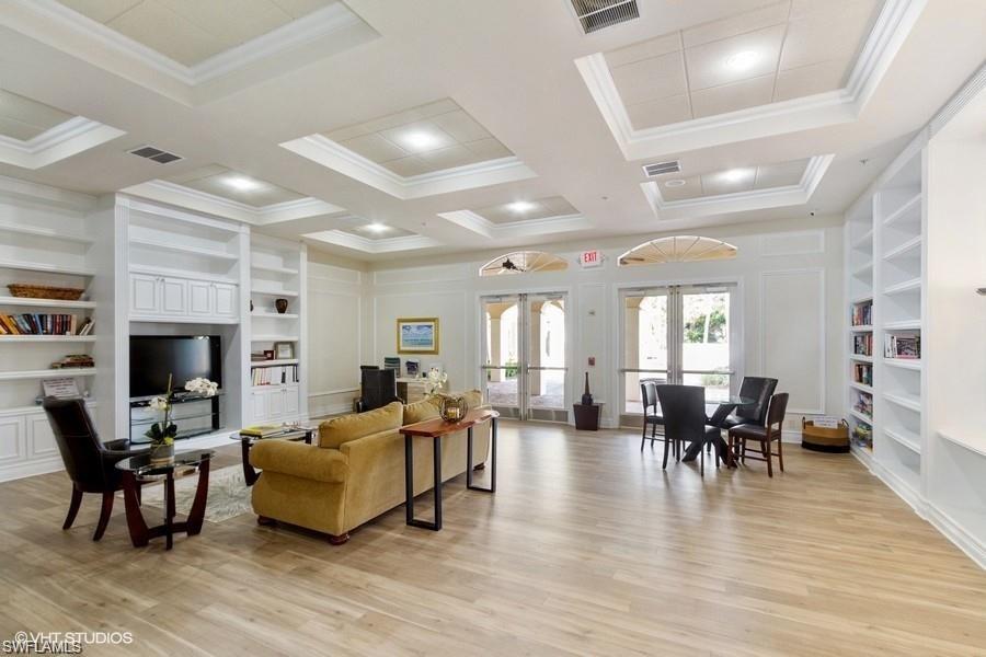 9387 Springview Loop Estero, FL 33928 - Photo 36 of 39 a living room with fireplace furniture and a wooden floor