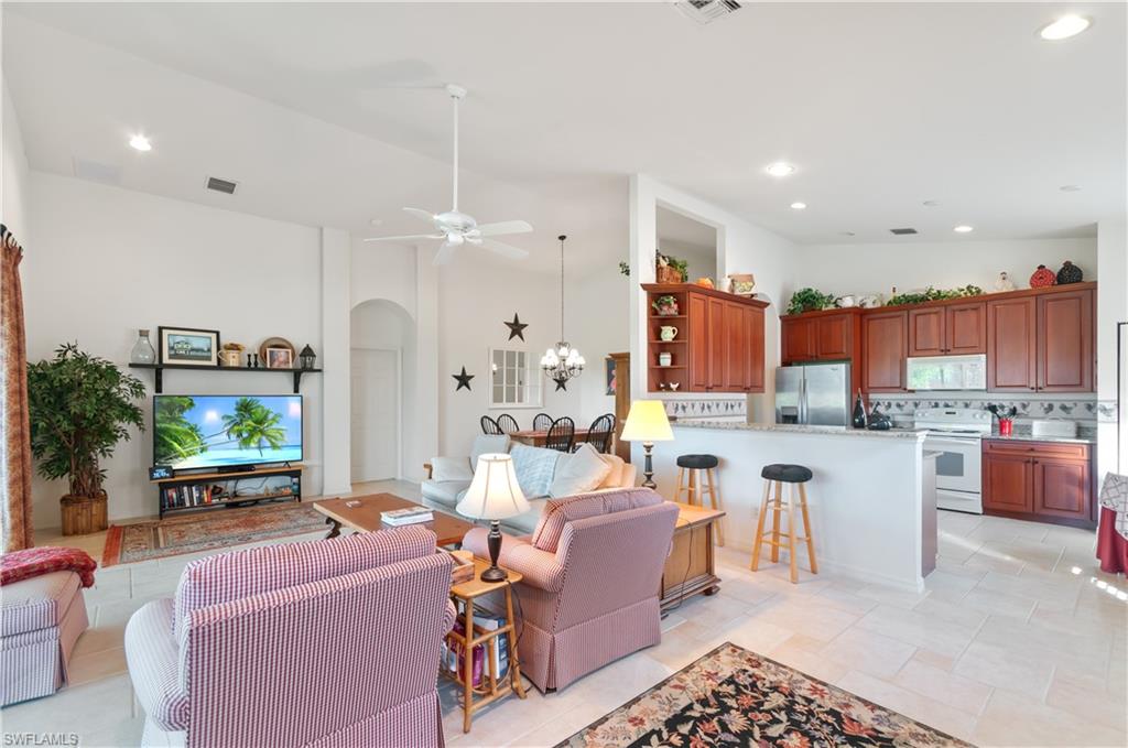 9387 Springview Loop Estero, FL 33928 - Photo 5 of 39 a living room with stainless steel appliances kitchen island granite countertop furniture and a view of kitchen