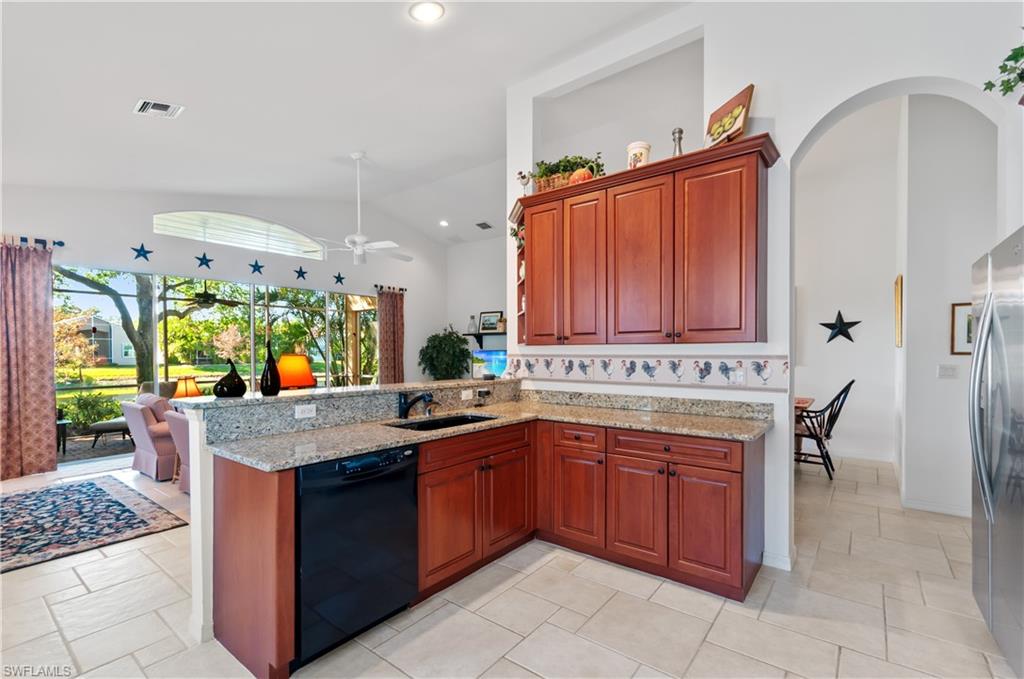 9387 Springview Loop Estero, FL 33928 - Photo 8 of 39 a kitchen with a sink stove and cabinets