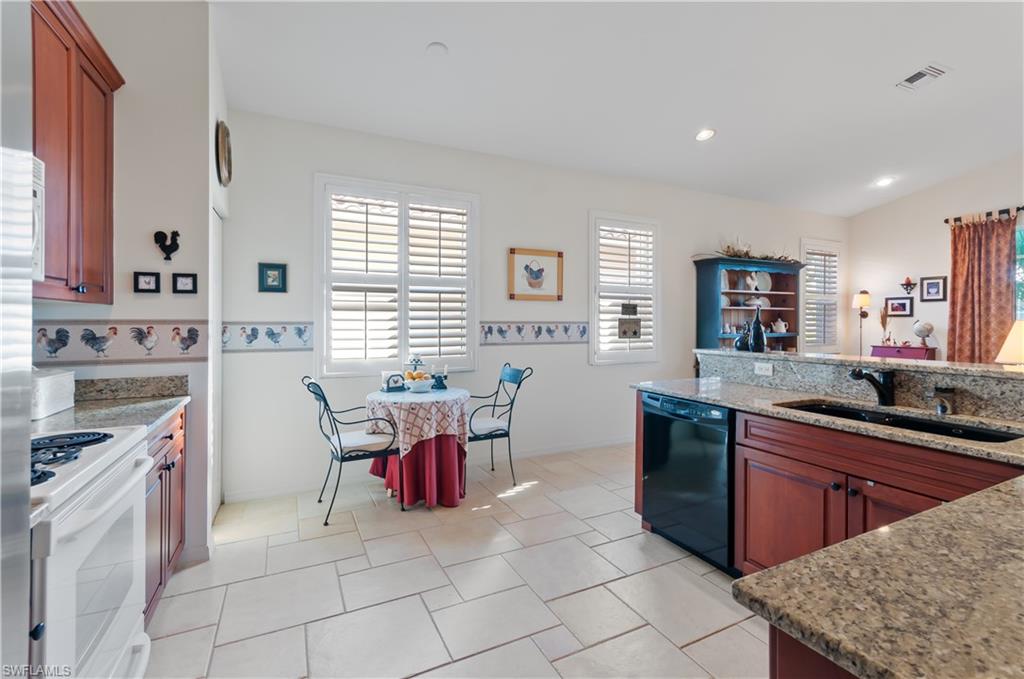 9387 Springview Loop Estero, FL 33928 - Photo 10 of 39 a kitchen with cabinets and chairs