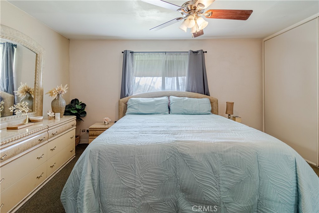10654 White Oak Drive Riverside, CA 92505 - Photo 11 of 29 a bedroom with a large bed and a chandelier