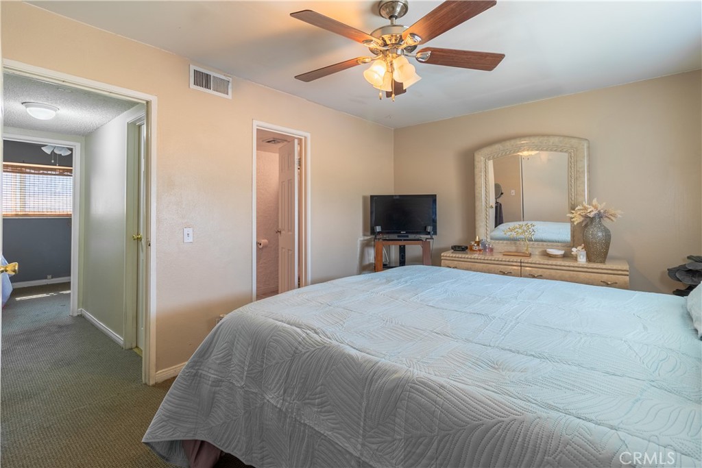 10654 White Oak Drive Riverside, CA 92505 - Photo 12 of 29 a bedroom with a bed and a chandelier