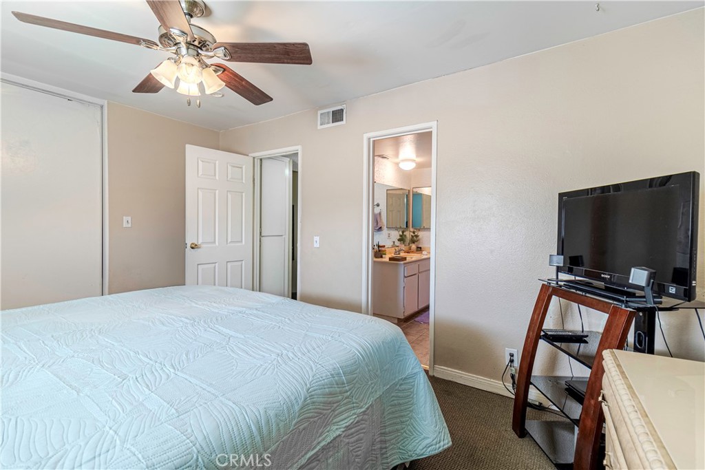 10654 White Oak Drive Riverside, CA 92505 - Photo 13 of 29 a bedroom with a bed and a flat screen tv