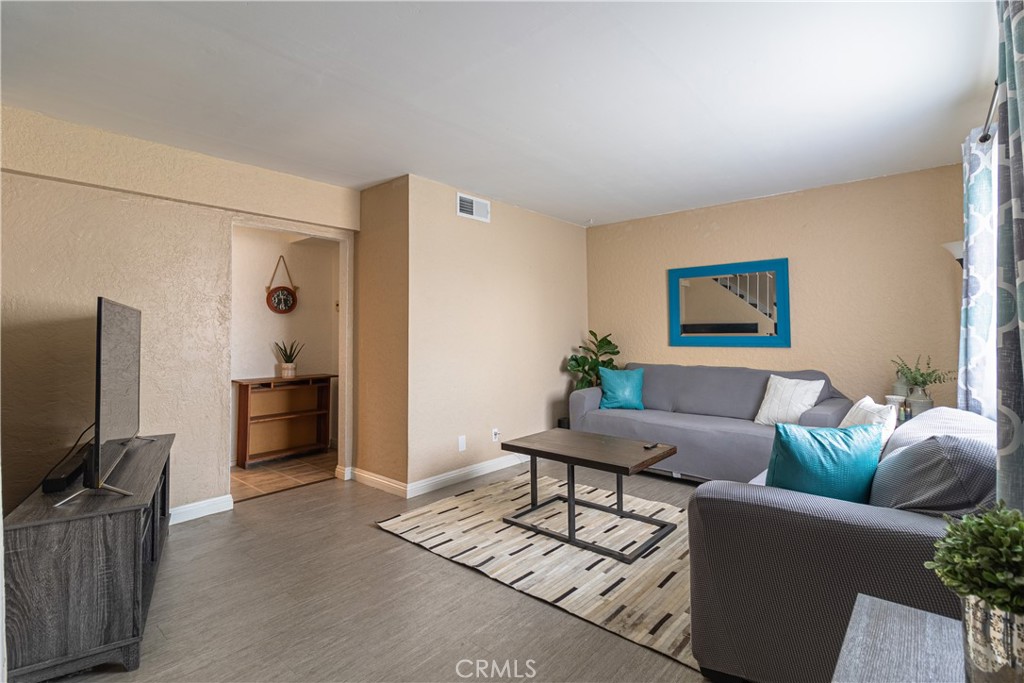 10654 White Oak Drive Riverside, CA 92505 - Photo 3 of 29 a living room with furniture a flat screen tv and a refrigerator