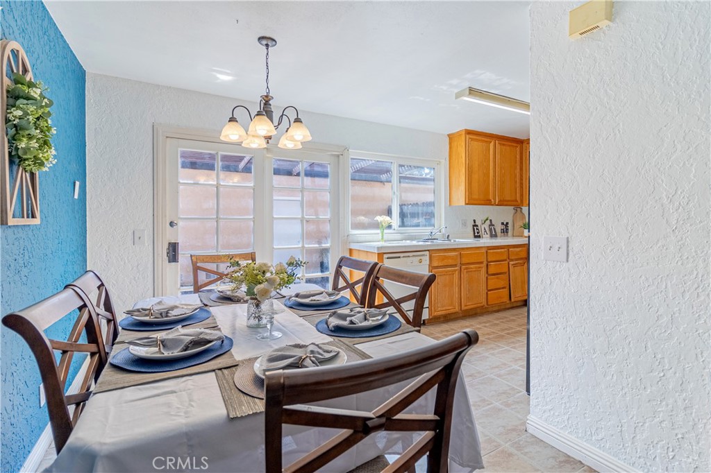 10654 White Oak Drive Riverside, CA 92505 - Photo 4 of 29 a view of a dining room with furniture a chandelier and a window