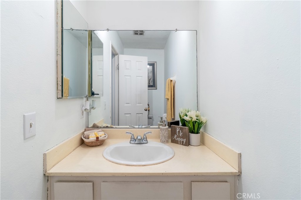 10654 White Oak Drive Riverside, CA 92505 - Photo 7 of 29 a bathroom with a sink and a mirror