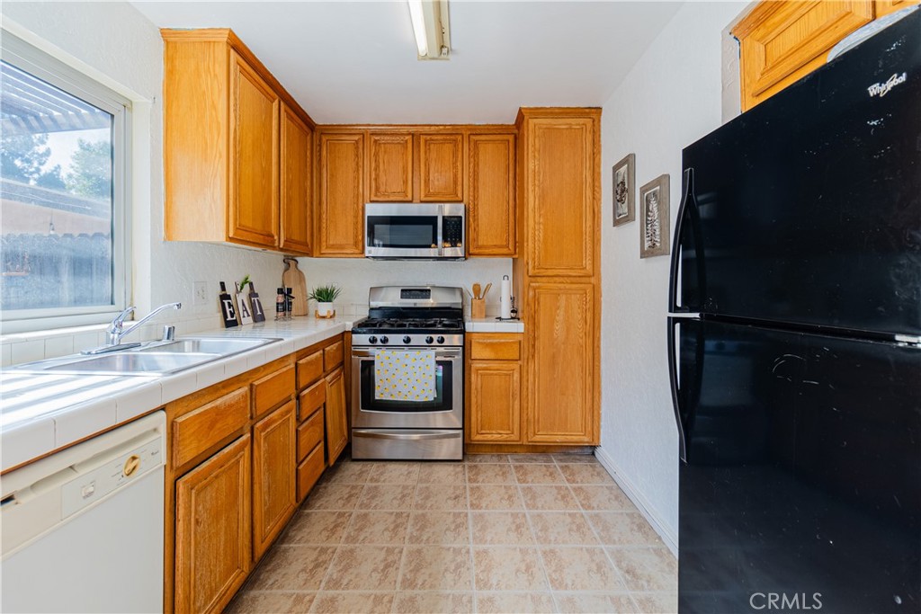10654 White Oak Drive Riverside, CA 92505 - Photo 10 of 29 a kitchen with stainless steel appliances granite countertop a refrigerator stove top oven a sink and dishwasher
