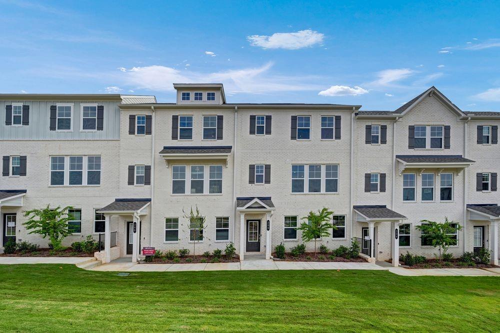 a front view of building with yard and windows