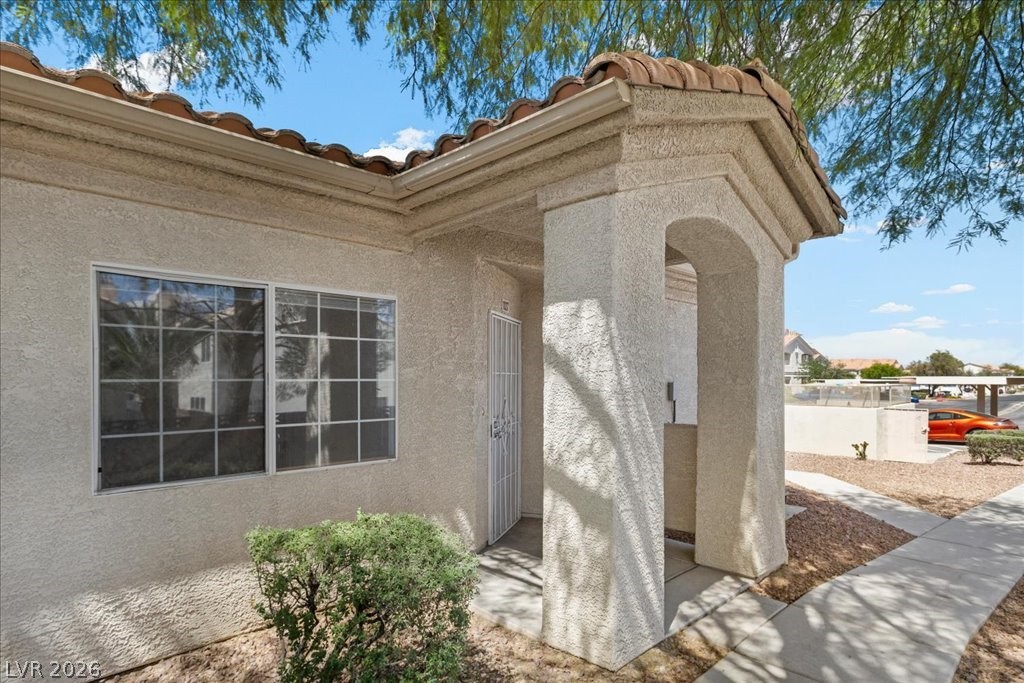 1881 West Alexander Road, Unit 1037 North Las Vegas, NV 89032 - Photo 26 of 31 A welcoming front entrance with arched details invites you into this comfortable dwelling.