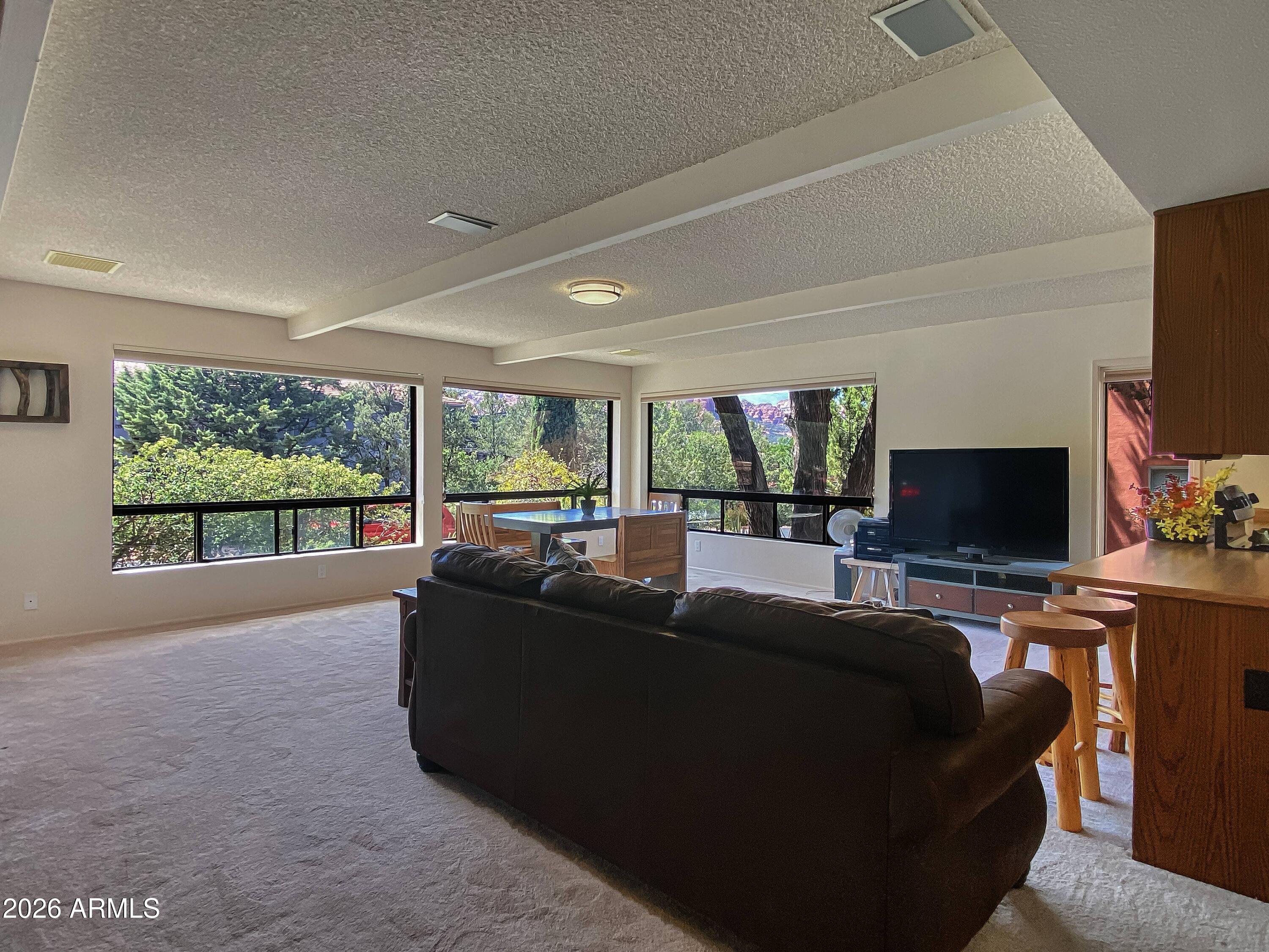 550 Barcelona Road Sedona, AZ 86336 - Photo 5 of 32 a living room with furniture and a flat screen tv
