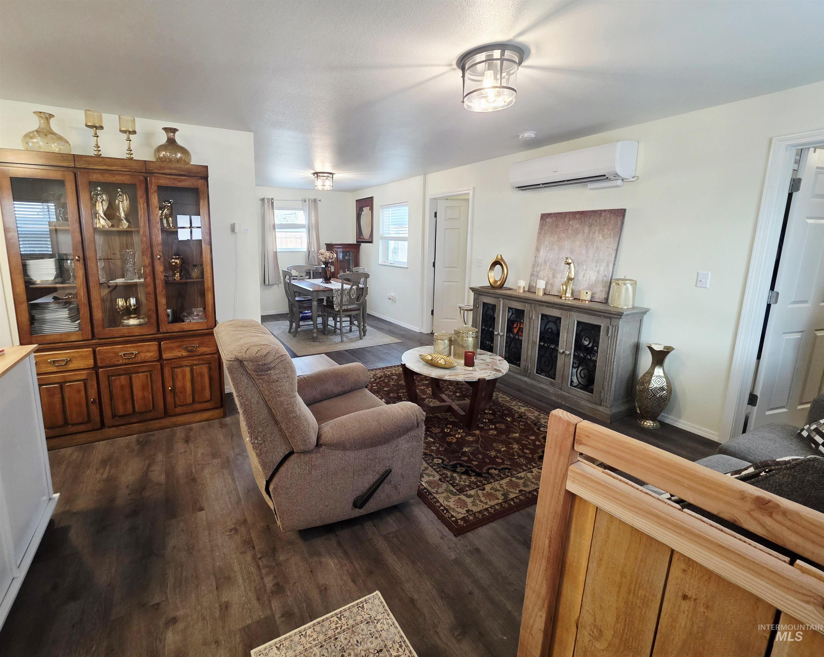 409 8th Street Clarkston, WA 99403 - Photo 2 of 23 Wood-finish flooring throughout, ceiling-mounted lighting fixtures, built-in air conditioning unit, and a visible dining area
