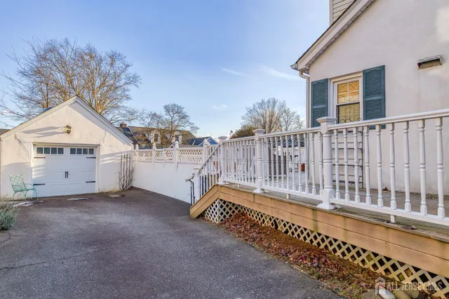a view of a house with a small yard and wooden fence