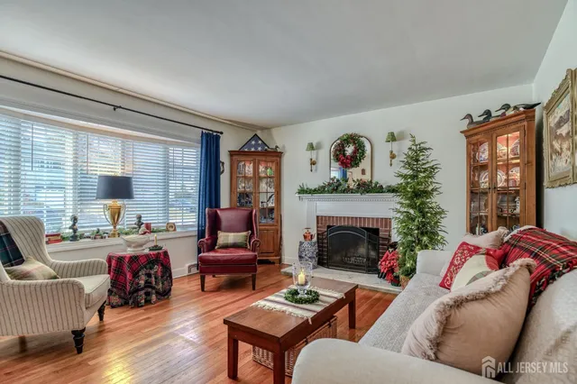 a living room with furniture fireplace and a large window