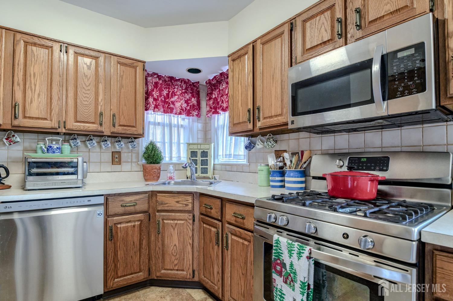 58 Harrison Avenue Milltown, NJ 08850 - Photo 10 of 30 a kitchen with stainless steel appliances granite countertop a stove top oven a sink dishwasher and cabinets with wooden floor