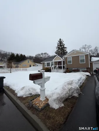 a view of a house with yard and lake view