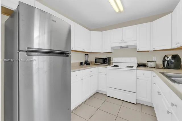 a kitchen with cabinets stainless steel appliances and a counter top
