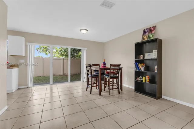 a livingroom with furniture and a floor to ceiling window