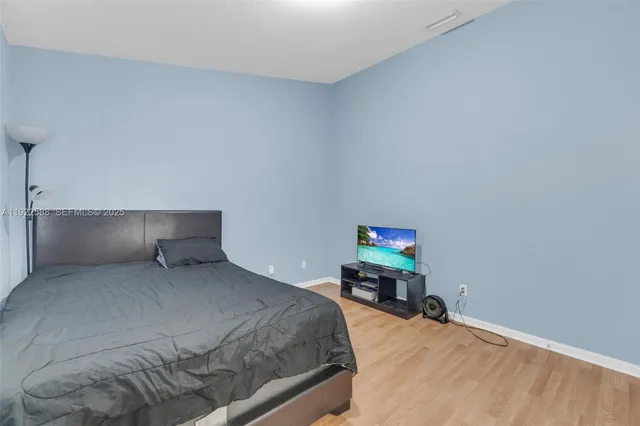 a bedroom with a bed and a desk
