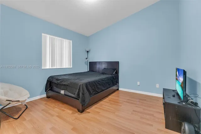 a bedroom with a bed and flat screen tv
