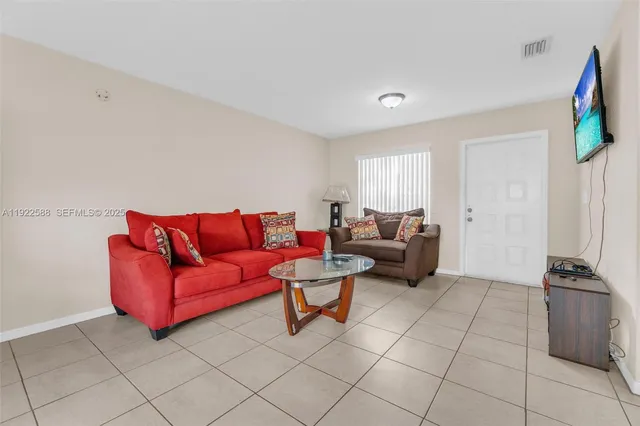 a living room with furniture and a flat screen tv