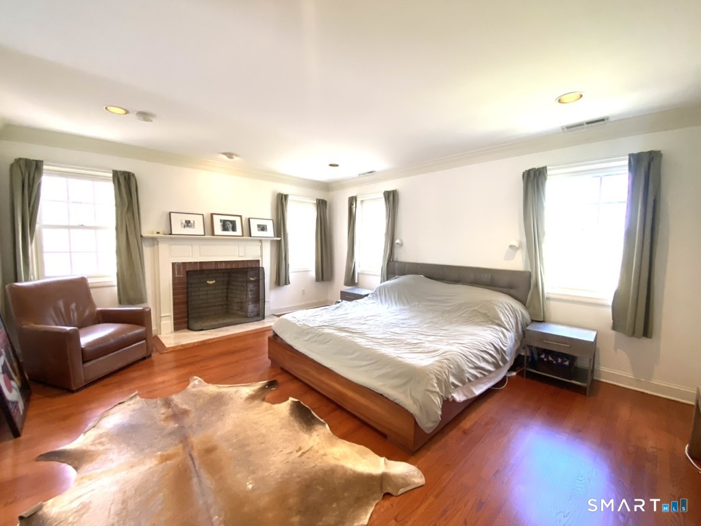 12 Carriage Hill Road Woodbridge, CT 06525 - Photo 14 of 24 a spacious bedroom with a bed and a fireplace