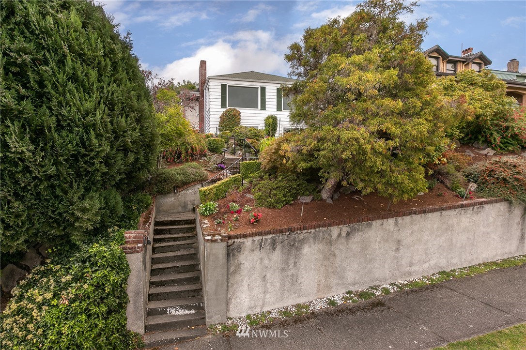 6712 42nd Avenue Southwest Seattle, WA 98136 - Photo 1 of 19 a view of a yard with plants and wooden fence