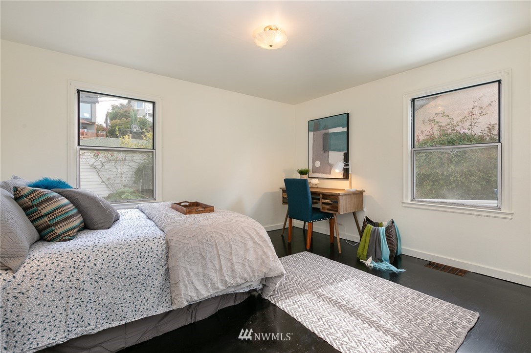 6712 42nd Avenue Southwest Seattle, WA 98136 - Photo 14 of 19 a bedroom with a bed and a table in it