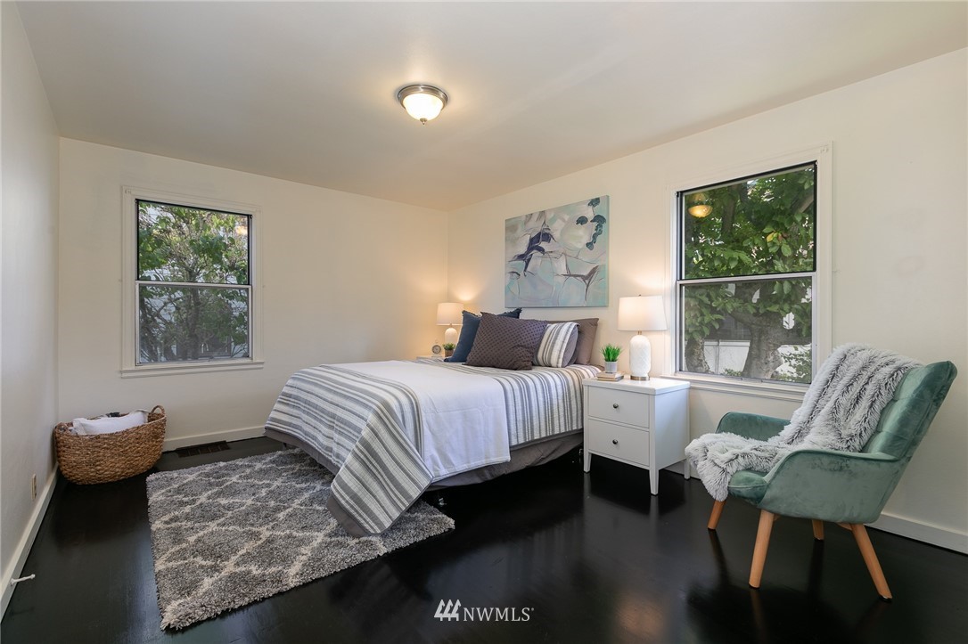 6712 42nd Avenue Southwest Seattle, WA 98136 - Photo 16 of 19 a bedroom with a bed and a window