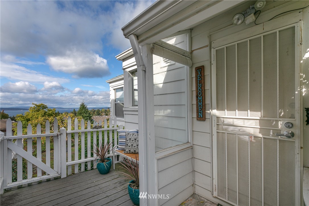 6712 42nd Avenue Southwest Seattle, WA 98136 - Photo 4 of 19 a view of a balcony with wooden floor and fence
