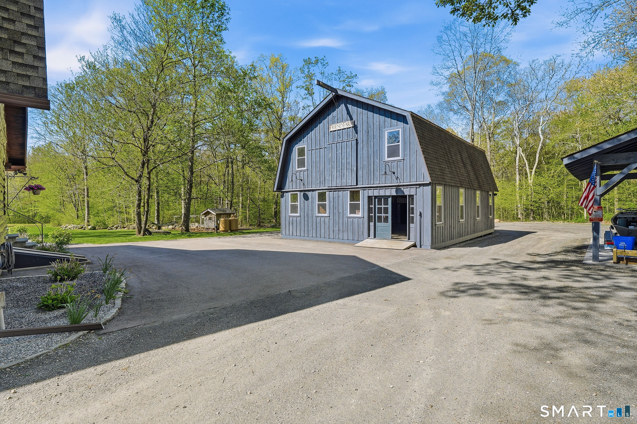 61 Mystic Road North Stonington, CT 06359 - Photo 3 of 40 a front view of a house with a yard and garage