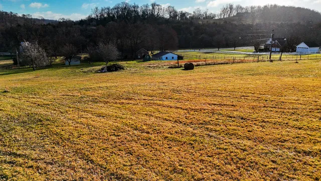 a view of a swimming pool with an outdoor seating and a yard