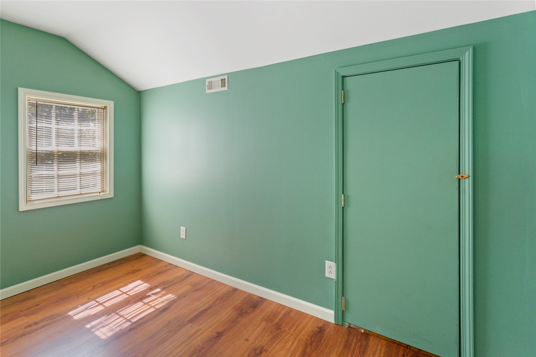 621 Burns Mill Road West Union, SC 29696 - Photo 13 of 45 A compact bedroom with an angled ceiling and warm hardwood-style flooring awaits your personal touch.