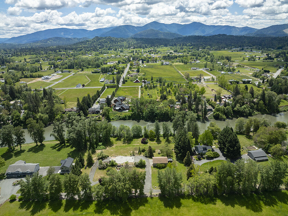 0 Lower River Road, Unit TL#108 Grants Pass, OR 97526 - Photo 32 of 47 an aerial view of residential houses with outdoor space and trees