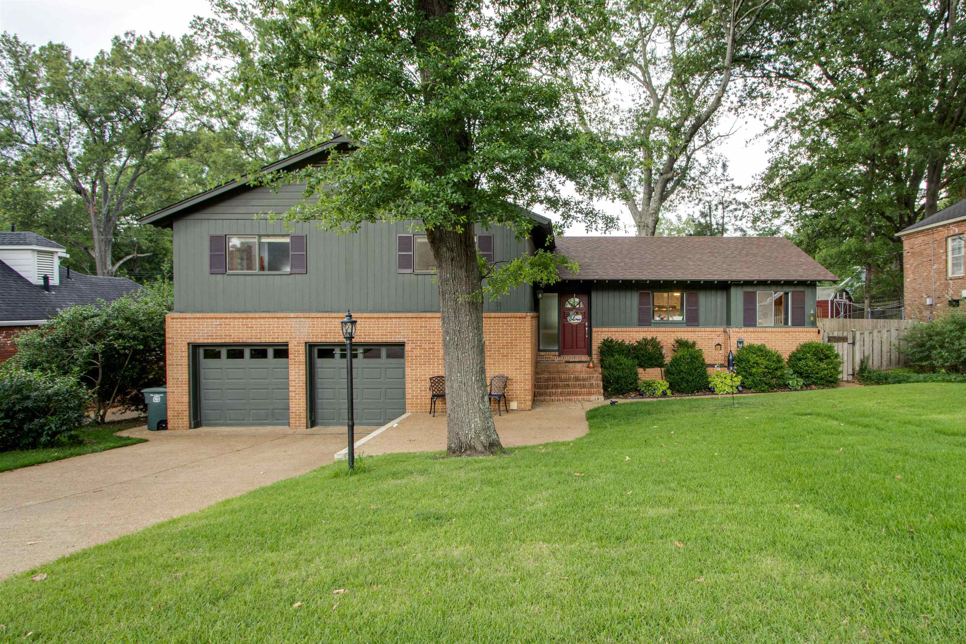 5636 Barfield Road Memphis, TN 38120 - Photo 1 of 25 a view of a house with a yard and large tree