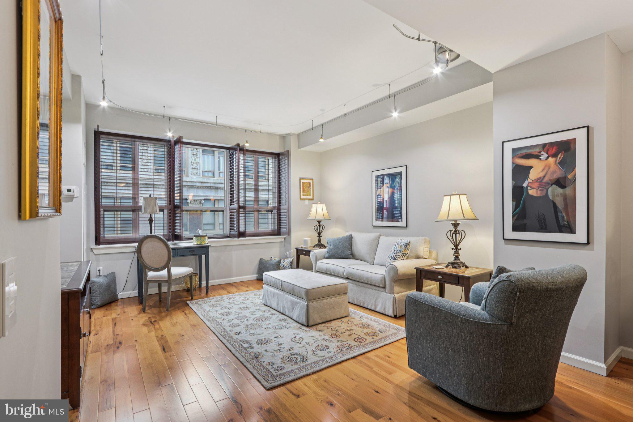 1425 Locust Street, Unit 7D Philadelphia, PA 19102 - Photo 12 of 39 a living room with furniture and a window