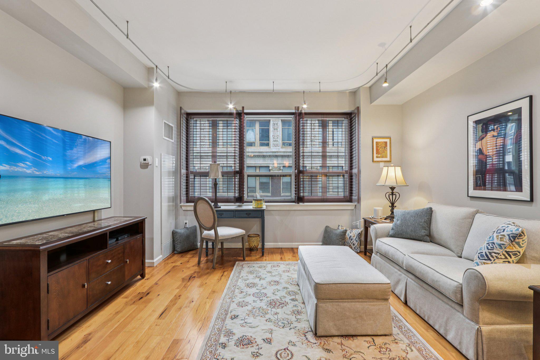 1425 Locust Street, Unit 7D Philadelphia, PA 19102 - Photo 13 of 39 a living room with furniture and a flat screen tv